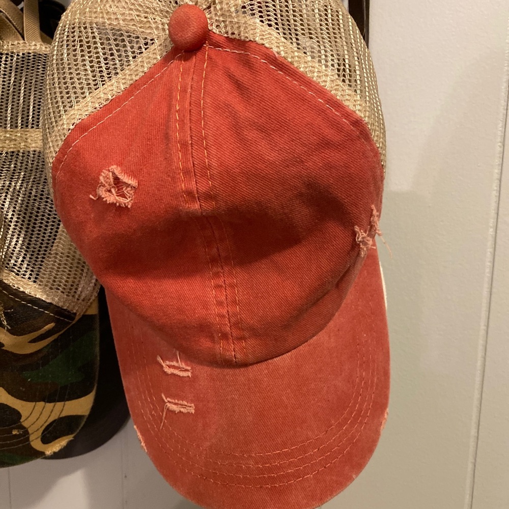 Orange ragged stretchable baseball hat. Adjustable